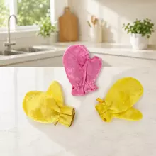 Cleaning glove used by hand to wipe grease from a kitchen surface.