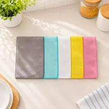 Double-layer wood fiber dishcloth laid flat for kitchen counter and table wiping.
